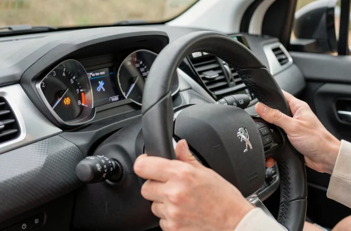 Gros plan sur le voyant clé à molette allumé sur le tableau de bord d'une Peugeot 208